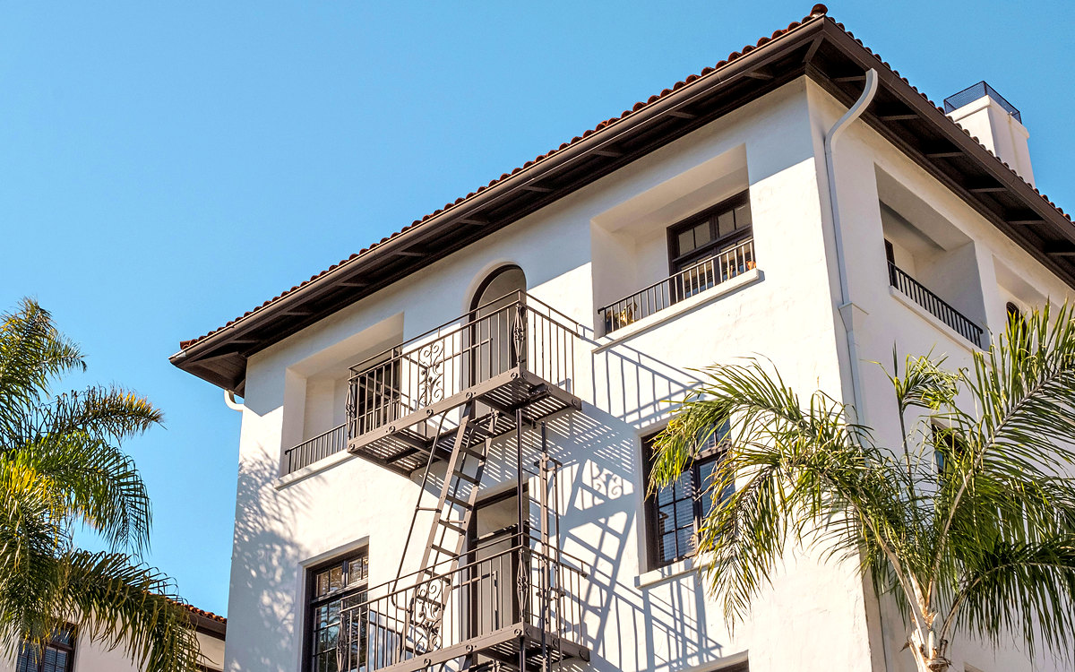 Spanish Revival apartment building with palm trees, Los Angeles