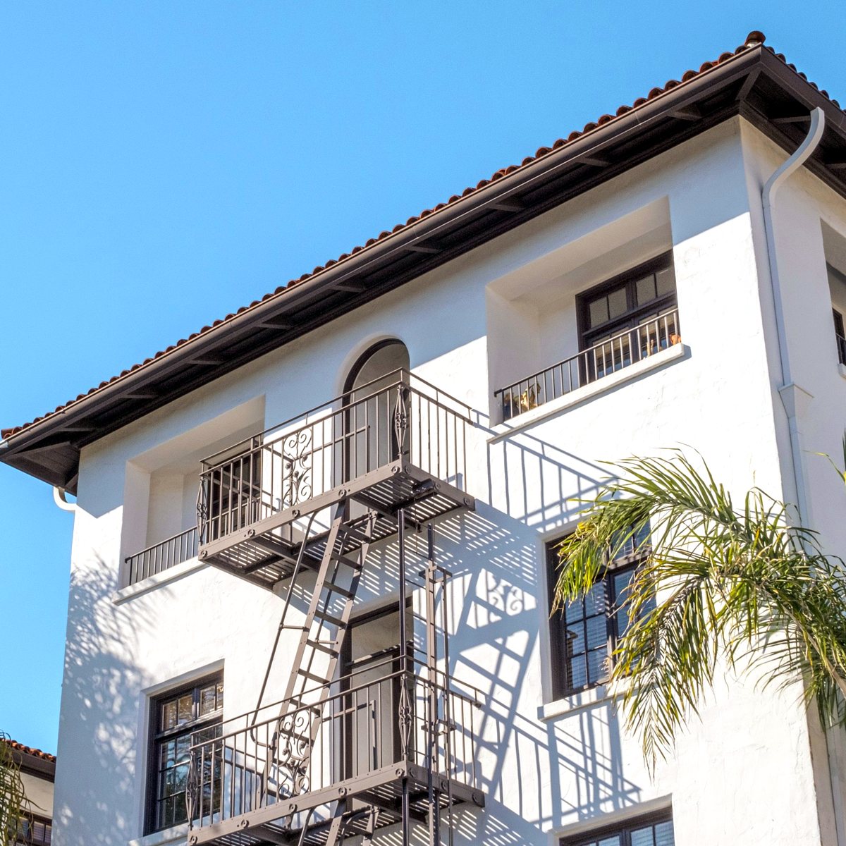 Spanish Revival apartment building with palm trees, Los Angeles