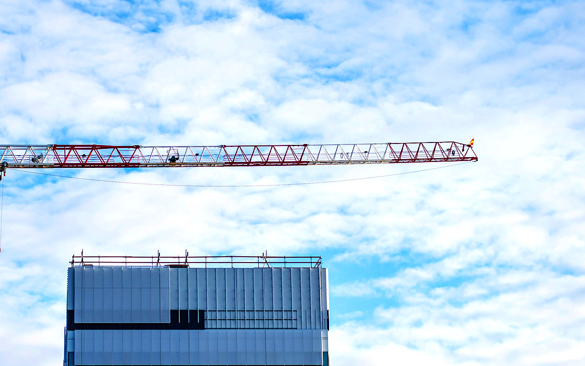 Tower crane beside a building under construction