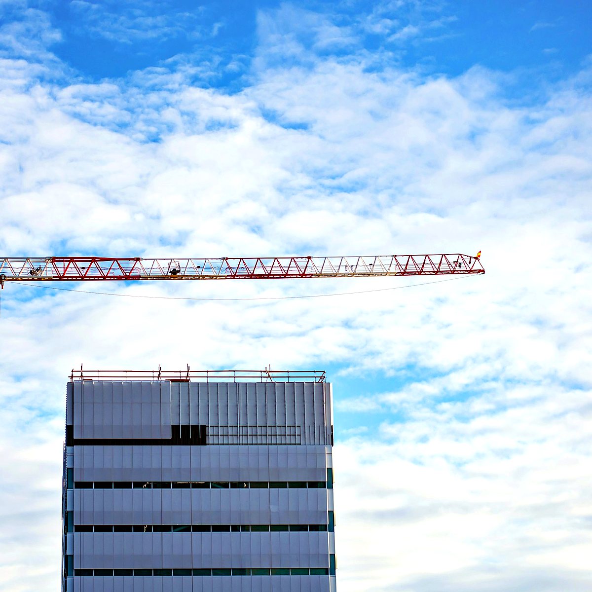 Tower crane beside a building under construction